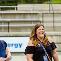 Two guests laughing on the field at the Jamie Hosford Football Center dedication.